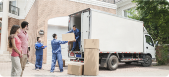 Movers unloading boxes from a truck while couple watches