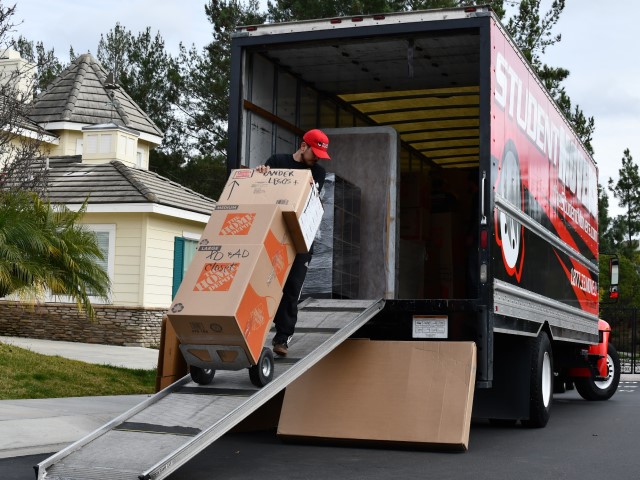 Movers with a truck unloading boxes