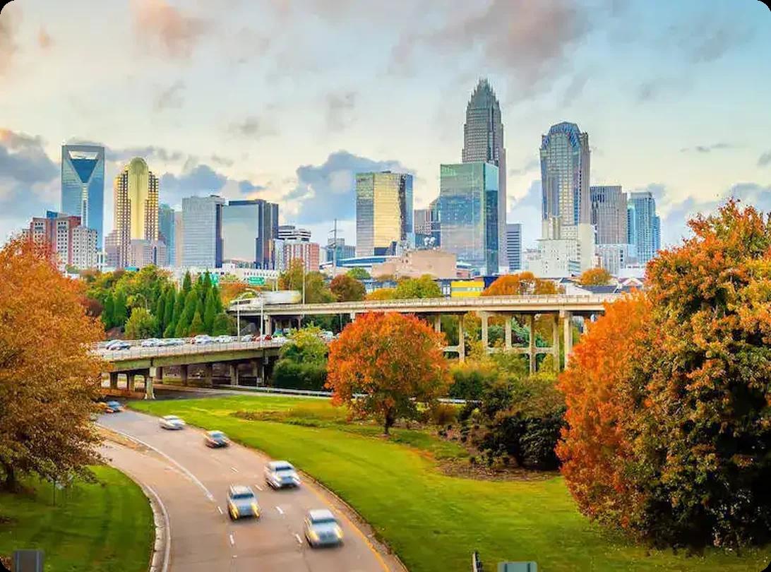Charlotte, NC skyline at sunset with fall foliage in the foreground