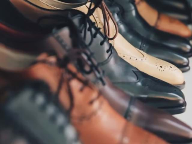 Several different styles of leather shoes in a line